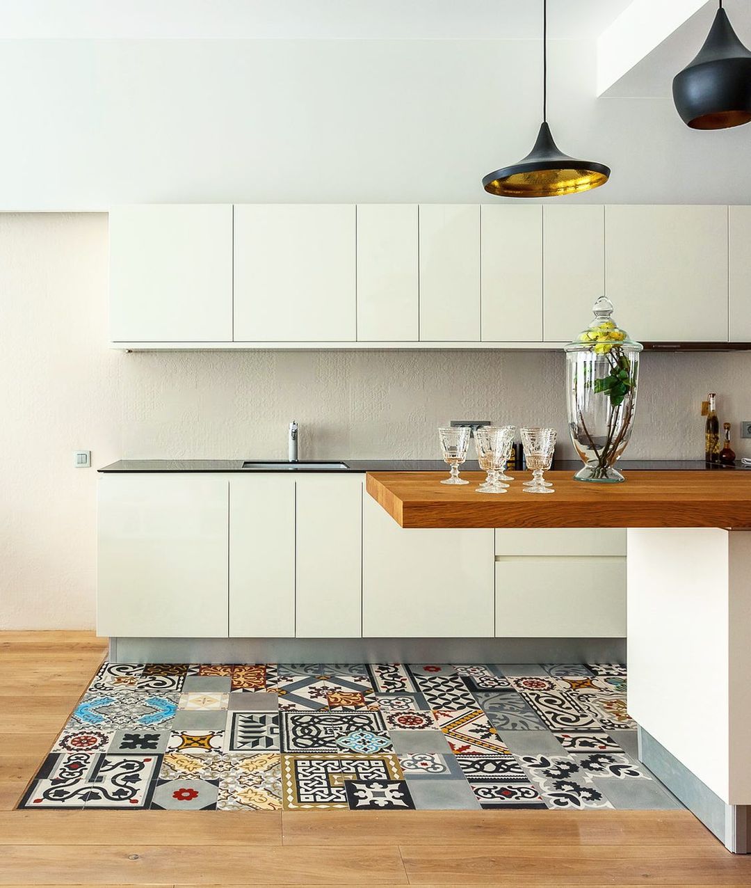 Patchwork tiles are often seen on characterful farmhouse-style kitchen walls but they can also work surprisingly well in contemporary-style kitchens, providing a striking contrast between sleek cabinets and neutral colours.